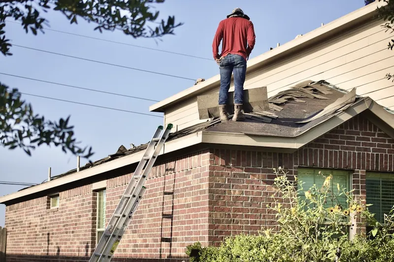 Professional roofer working on a residential roof in Echo